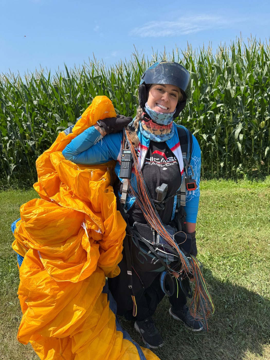 A pilot with her wing in front of the cornfield