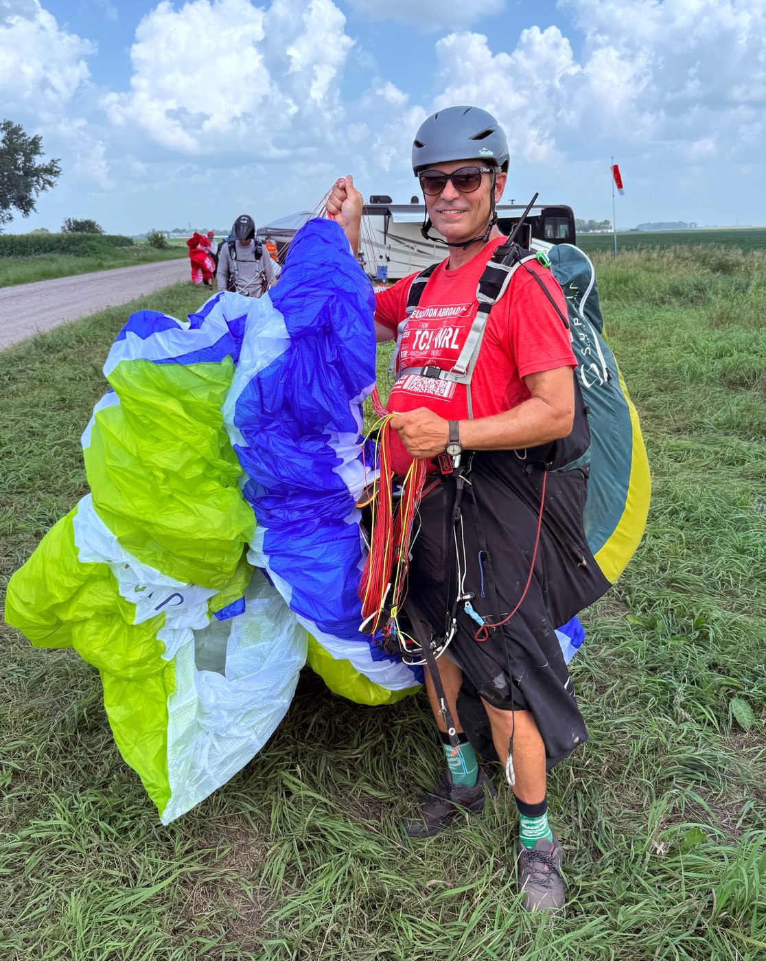 A pilot with his wing packed up after a flight