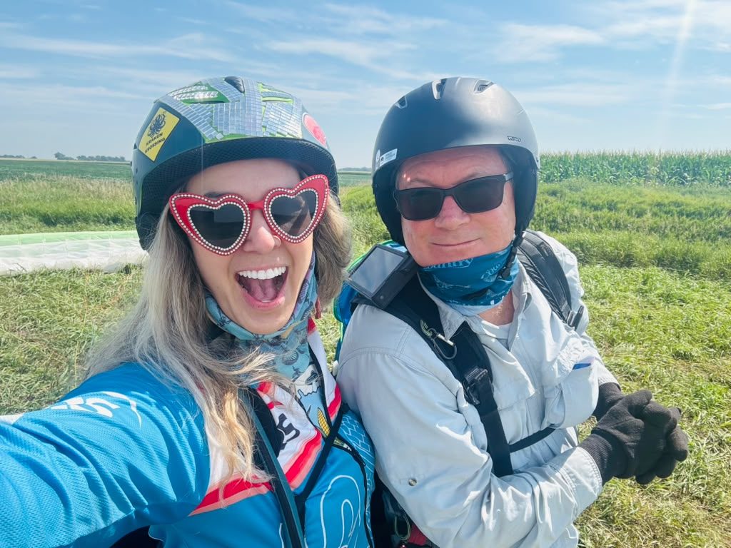 Two pilots smiling for a selfie in the field